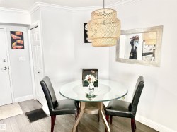 Dining space featuring wood finished floors and ornamental molding - 