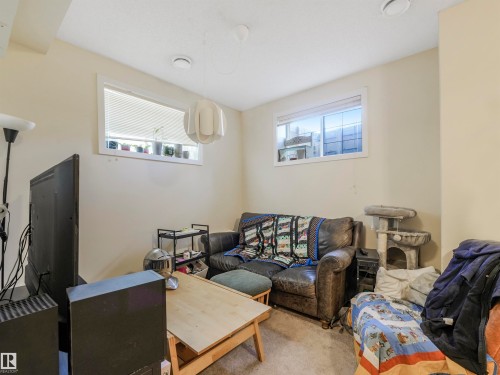 Spacious basement living room area with high ceilings. - 10943 76 Avenue, Edmonton, AB - Indoor Photo Showing Living Room