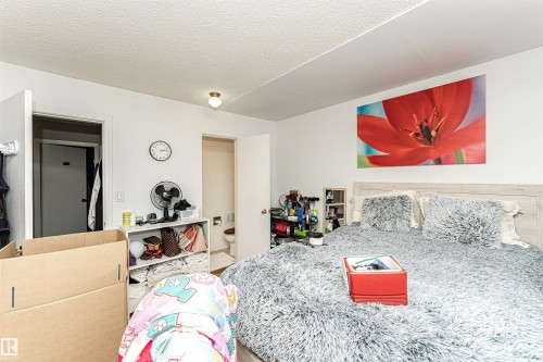 Bedroom featuring ensuite bath and a textured ceiling - 2349 Millbourne Road W, Edmonton, AB - Indoor Photo Showing Bedroom