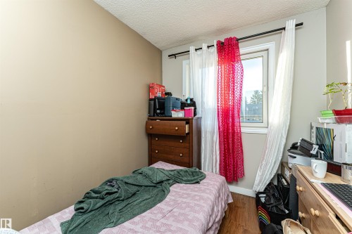 Bedroom featuring wood finished floors and a textured ceiling - 2349 Millbourne Road W, Edmonton, AB - Indoor Photo Showing Bedroom