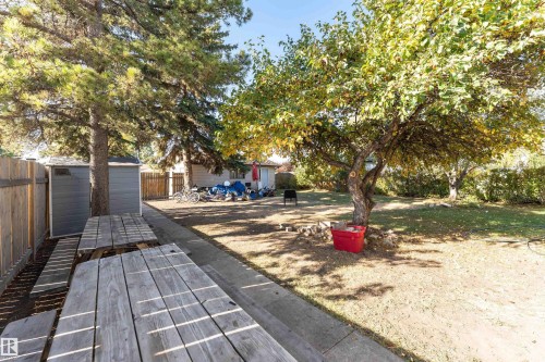 Fenced backyard featuring a storage unit and a patio area - 2349 Millbourne Road W, Edmonton, AB - Outdoor
