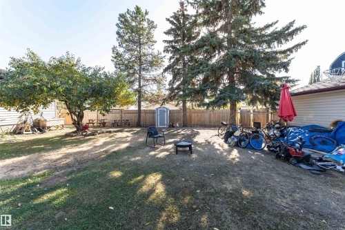Fenced backyard with a storage shed and a patio area - 2349 Millbourne Road W, Edmonton, AB - Outdoor