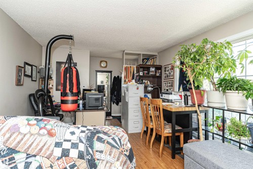 Bedroom featuring light wood-type flooring and a textured ceiling - 2349 Millbourne Road W, Edmonton, AB - Indoor