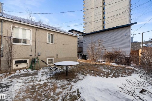 View of home's exterior featuring stucco siding and a patio area - 10124 88 Avenue, Edmonton, AB - Outdoor With Exterior