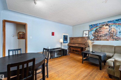 Living room featuring light wood-type flooring and a textured ceiling - 10124 88 Avenue, Edmonton, AB - Indoor Photo Showing Other Room