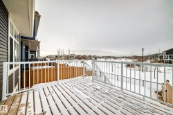 Snow covered deck with a residential view - 