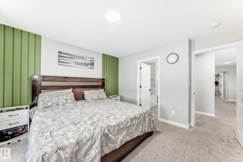Bedroom featuring light colored carpet and ensuite bath - 4930 Hawthorn Place, Edmonton, AB - Indoor Photo Showing Bedroom
