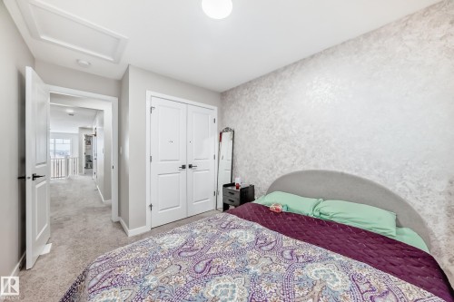 Bedroom featuring attic access, light carpet, and a closet - 4930 Hawthorn Place, Edmonton, AB - Indoor Photo Showing Bedroom