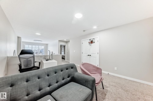 Living area featuring light colored carpet and recessed lighting - 4930 Hawthorn Place, Edmonton, AB - Indoor