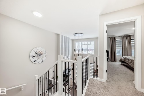 Corridor featuring light carpet and an upstairs landing - 4930 Hawthorn Place, Edmonton, AB - Indoor Photo Showing Other Room