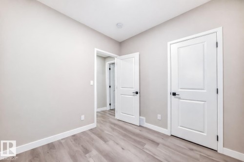 Unfurnished bedroom with baseboards and light wood-style floors - 4930 Hawthorn Place, Edmonton, AB - Indoor Photo Showing Other Room