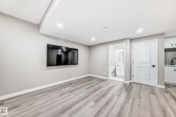 Below grade area with light wood finished floors and recessed lighting - 