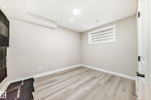 Spare room featuring light wood finished floors and baseboards - 4930 Hawthorn Place, Edmonton, AB - Indoor Photo Showing Other Room