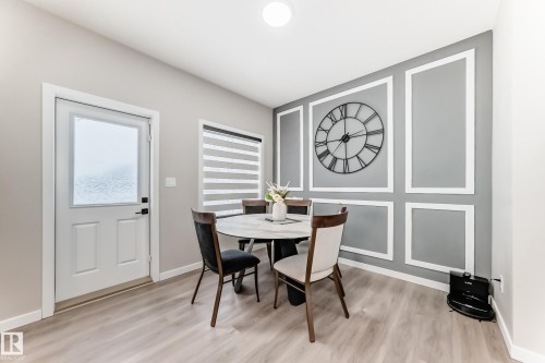 Dining area with light wood-style flooring and a decorative wall - 4930 Hawthorn Place, Edmonton, AB - Indoor Photo Showing Dining Room