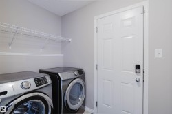 Washroom featuring washing machine and clothes dryer and a textured ceiling - 