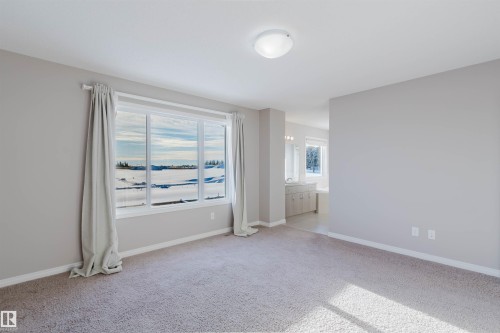 Unfurnished bedroom with baseboards and light colored carpet - 16627 18 Avenue, Edmonton, AB - Indoor