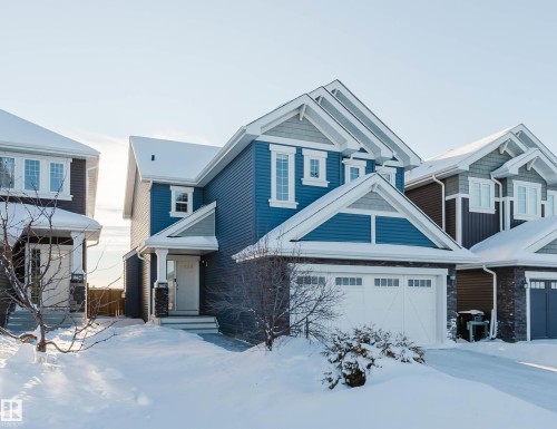 View of front of home featuring stone siding and a garage - 16627 18 Avenue, Edmonton, AB - Outdoor With Facade