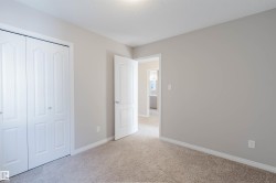 Unfurnished bedroom with light carpet, a closet, and a textured ceiling - 
