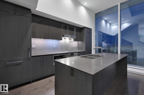 Kitchen with modern cabinets, light wood-type flooring, an island with sink, stainless steel appliances, and recessed lighting - 2303 10360 102 Street, Edmonton, AB - Indoor Photo Showing Kitchen With Double Sink With Upgraded Kitchen