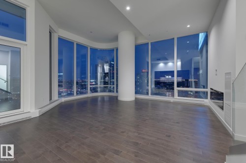 Empty room with dark wood finished floors and recessed lighting - 2303 10360 102 Street, Edmonton, AB - Indoor Photo Showing Other Room