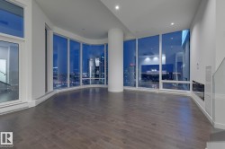 Empty room with dark wood finished floors and recessed lighting - 