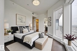 Bedroom with dark wood-style floors and a walk in closet - 