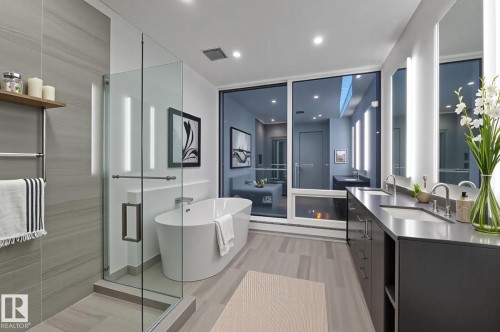 Bathroom featuring a freestanding bath, a stall shower, double vanity, and recessed lighting - 2303 10360 102 Street, Edmonton, AB - Indoor