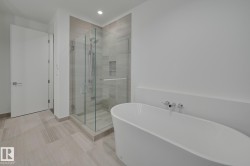 Full bath with a soaking tub, a shower stall, and recessed lighting - 