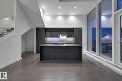 Kitchen with modern cabinets, recessed lighting, an island with sink, and dark wood finished floors - 