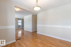 Spare room with a textured ceiling and light wood finished floors - 