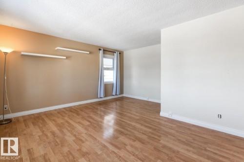 Spare room with a textured ceiling and light wood-style flooring - 7324 77 Street, Edmonton, AB - Indoor Photo Showing Other Room