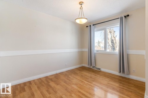 Spare room featuring a textured ceiling and light wood-style flooring - 7324 77 Street, Edmonton, AB - Indoor Photo Showing Other Room