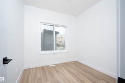 Empty room featuring baseboards and light wood finished floors - 