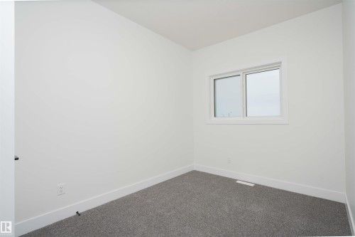 Carpeted spare room with baseboards - 430 Crystal Creek Link, Leduc, AB - Indoor Photo Showing Other Room