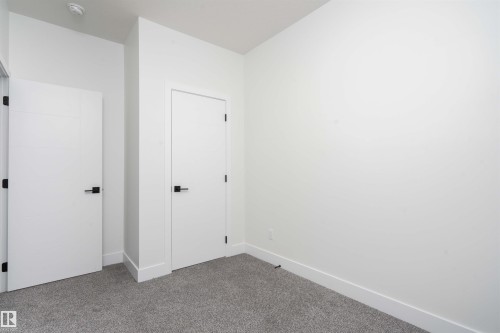 Unfurnished bedroom with baseboards and carpet floors - 430 Crystal Creek Link, Leduc, AB - Indoor Photo Showing Other Room