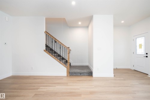 Foyer with light wood-style flooring, recessed lighting, and stairway - 430 Crystal Creek Link, Leduc, AB - Indoor Photo Showing Other Room
