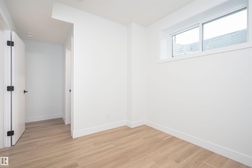 Unfurnished room featuring baseboards and light wood-style floors - 430 Crystal Creek Link, Leduc, AB - Indoor Photo Showing Other Room
