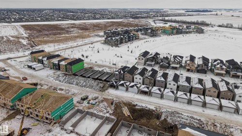 Snowy aerial view featuring a residential view - 430 Crystal Creek Link, Leduc, AB - Outdoor With View
