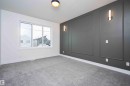 Empty room featuring carpet floors and a decorative wall - 430 Crystal Creek Link, Leduc, AB  - Indoor Photo Showing Other Room 