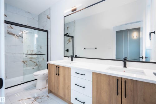Bathroom with double vanity, a marble finish shower, and light marble finish flooring - 430 Crystal Creek Link, Leduc, AB - Indoor Photo Showing Bathroom