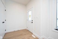 Doorway with wood finished floors and baseboards - 