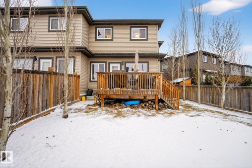 Snow covered back of property featuring a fenced backyard and a wooden deck - 17727 13 Avenue, Edmonton, AB - Outdoor With Deck Patio Veranda