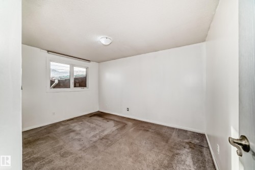 Carpeted spare room featuring baseboards - 131 Saskatchewan Avenue W, Devon, AB - Indoor Photo Showing Other Room