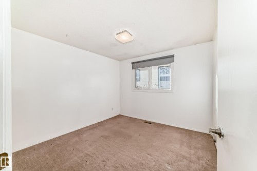 Empty room with carpet floors - 131 Saskatchewan Avenue W, Devon, AB - Indoor Photo Showing Other Room