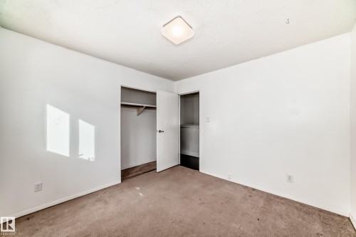 Unfurnished bedroom featuring carpet floors and a closet - 131 Saskatchewan Avenue W, Devon, AB - Indoor Photo Showing Other Room