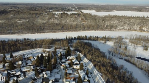 View of property location featuring a forest and nearby suburban area - 131 Saskatchewan Avenue W, Devon, AB - Outdoor With View