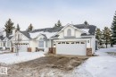 View of front of house featuring a garage, brick siding, driveway, and a shingled roof - 3240 38 Avenue, Edmonton, AB  - Outdoor With Facade 