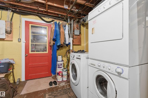 Washroom featuring concrete flooring and stacked washing machine and dryer - 10332 82 Street, Edmonton, AB - Indoor Photo Showing Laundry Room