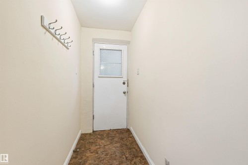 Entryway with baseboards and stone finish flooring - 10332 82 Street, Edmonton, AB - Indoor Photo Showing Other Room
