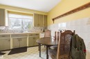 Kitchen with light flooring, light countertops, and tile walls - 10332 82 Street, Edmonton, AB  - Indoor 